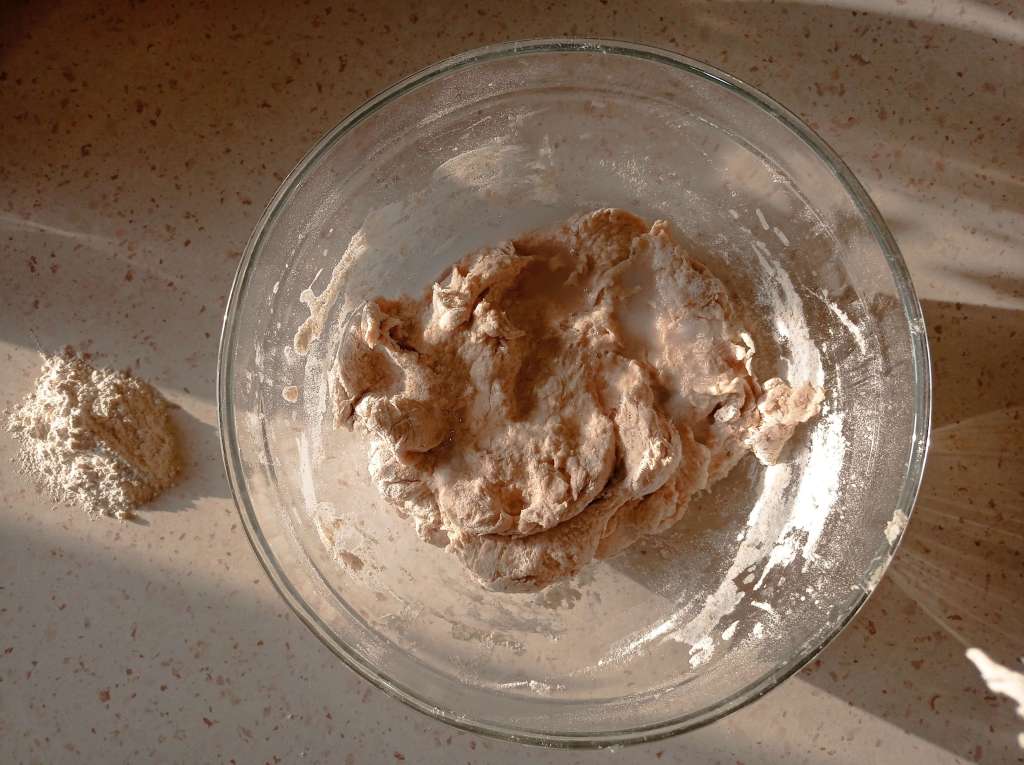 Bowl of bread dough with added water to dissolve and integrate salt