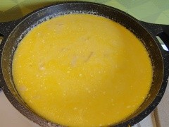 Traditional Romanian tripe soup with a creamy golden broth in the pot, after adding the egg and cream mixture.